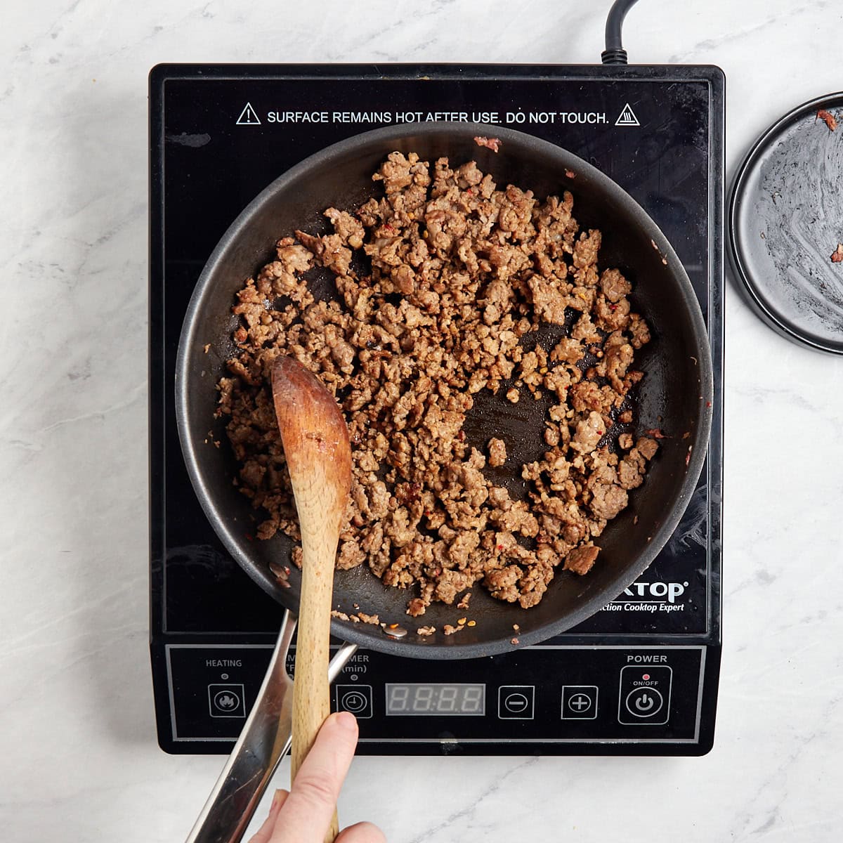 breakfast sausage cooking in a skillet.