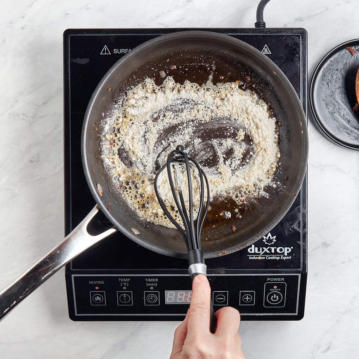 flour browning in a skillet with sausage fat.