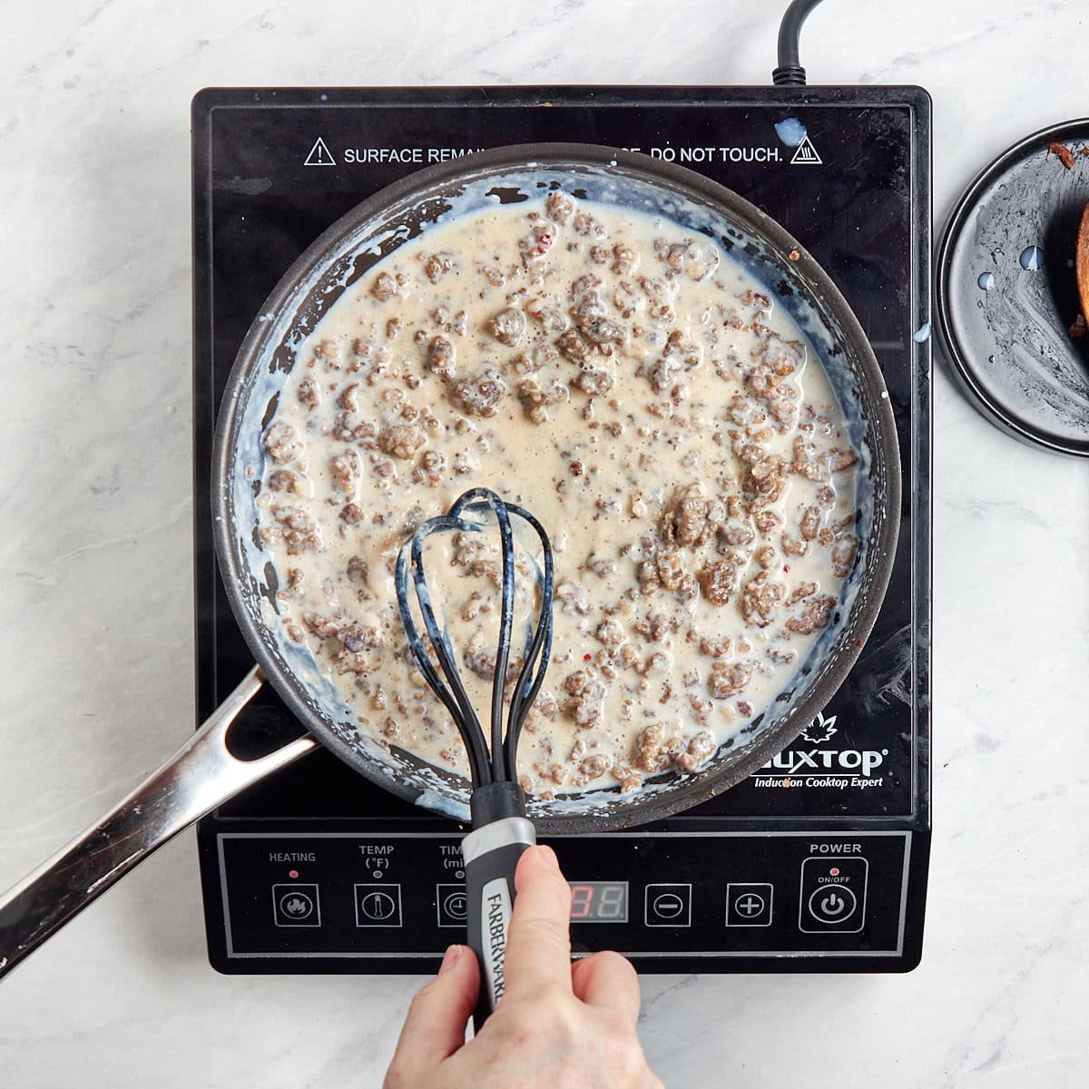 sausage in the skillet with the gravy.