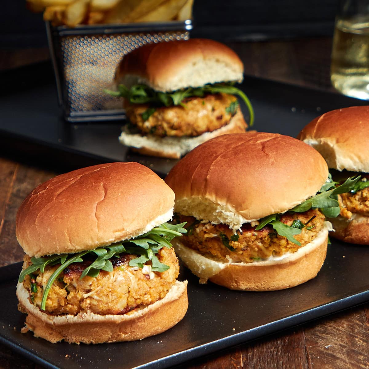 three sliders on a black plate.