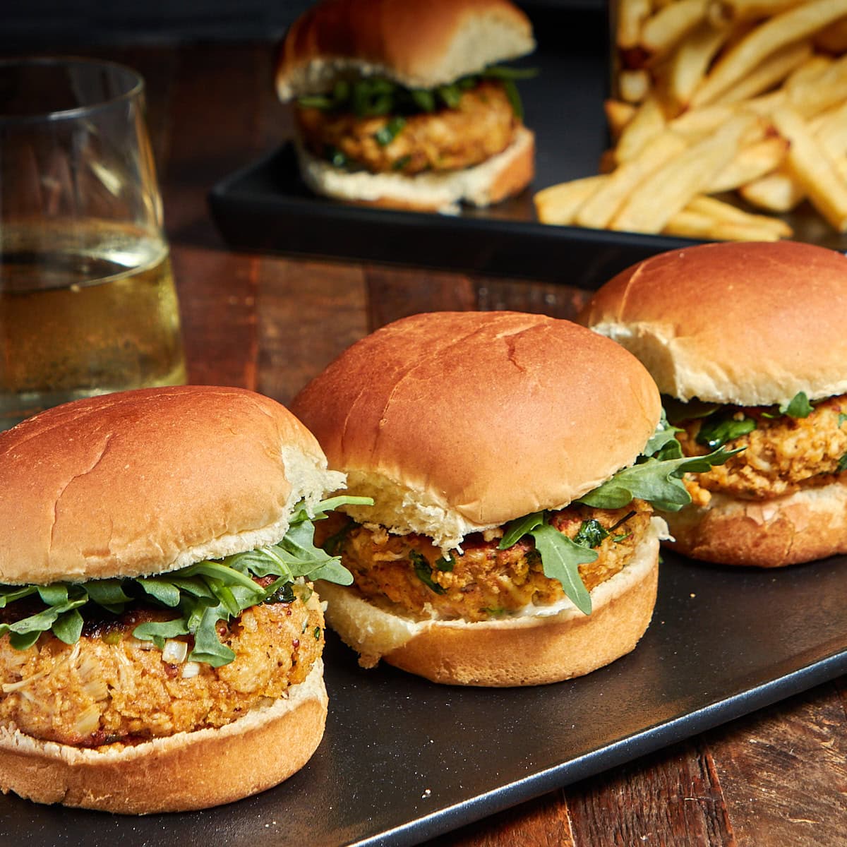 three sliders on a black plate.