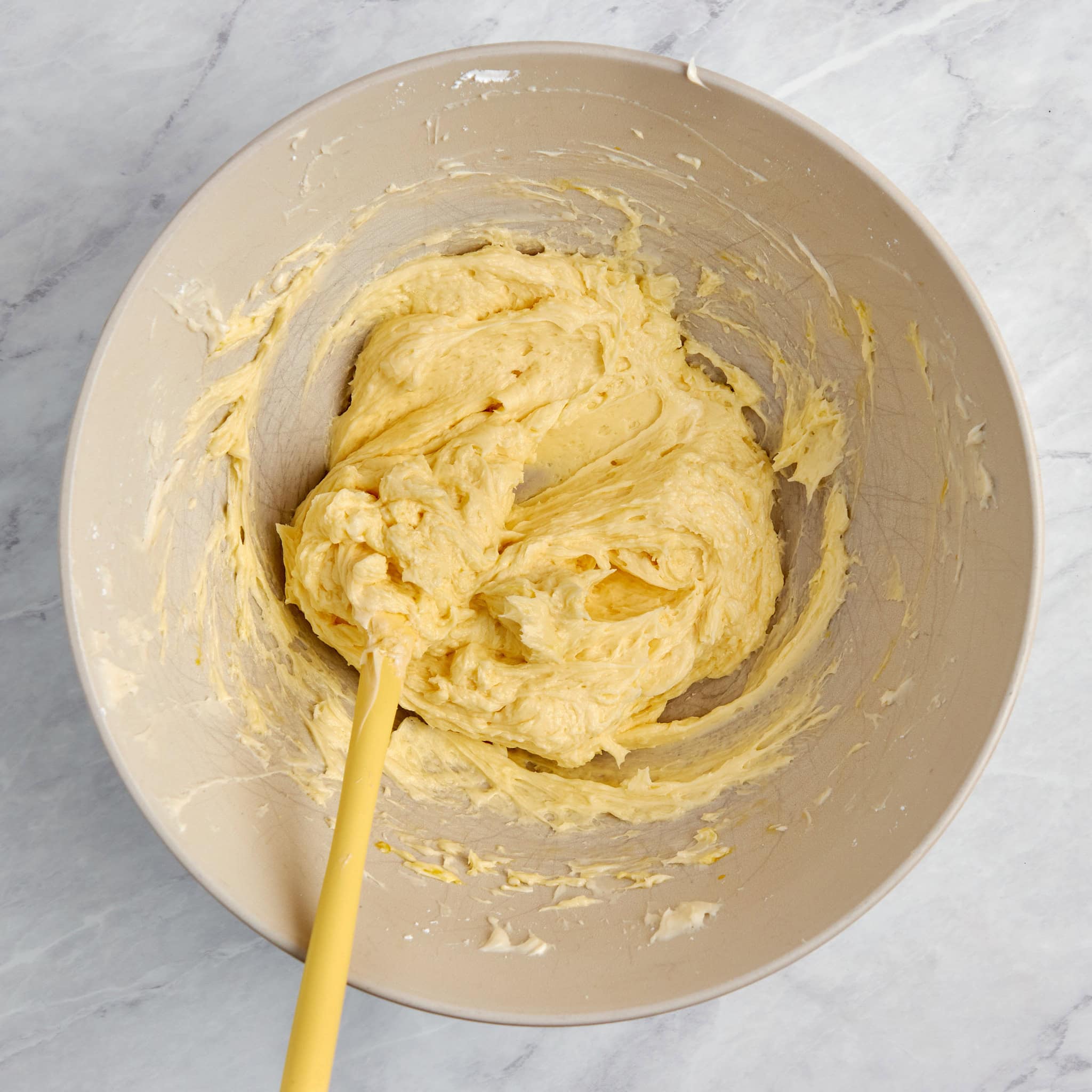 whipped egg whites, powder sugar in a mixing bowl.