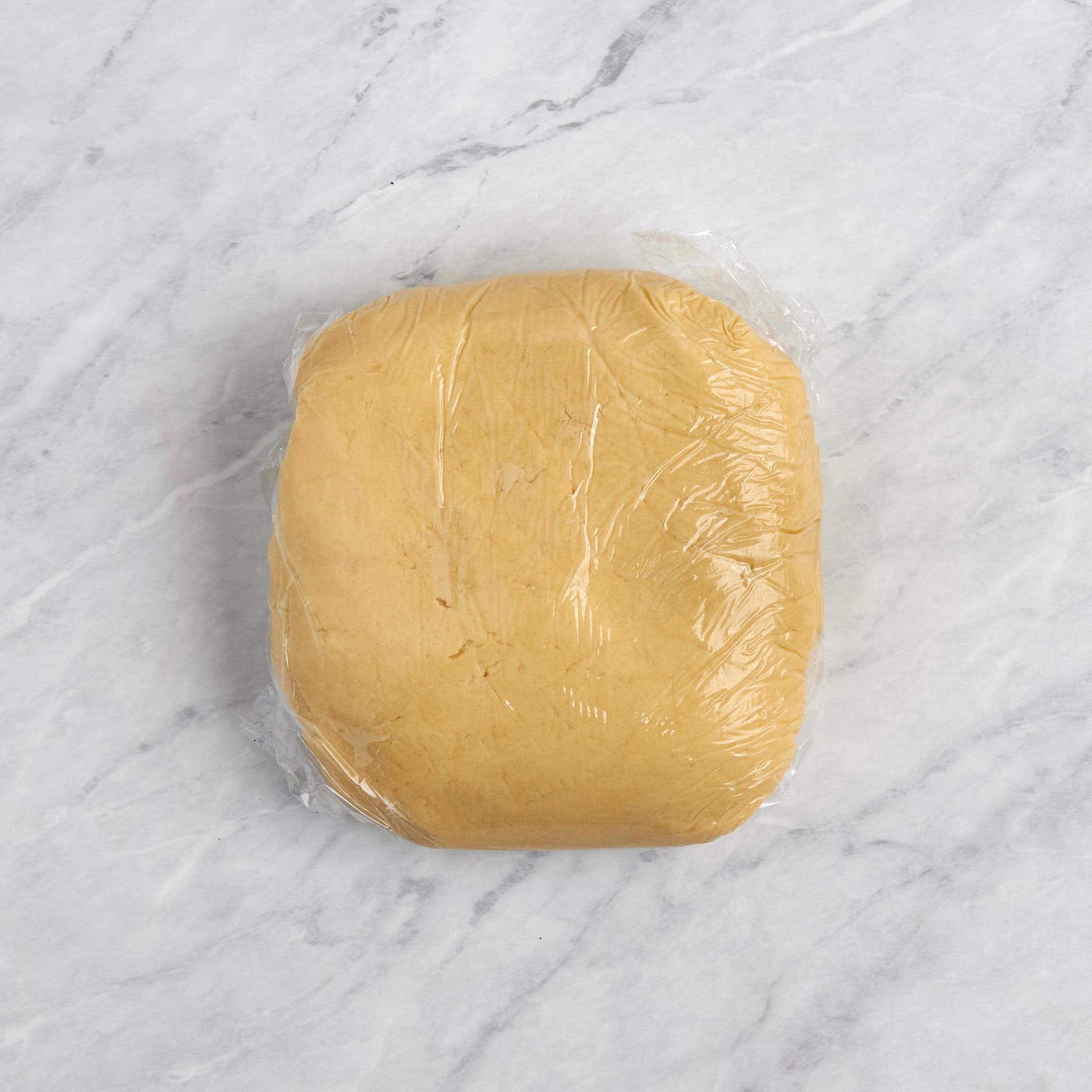 crust wrapped in plastic wrap.