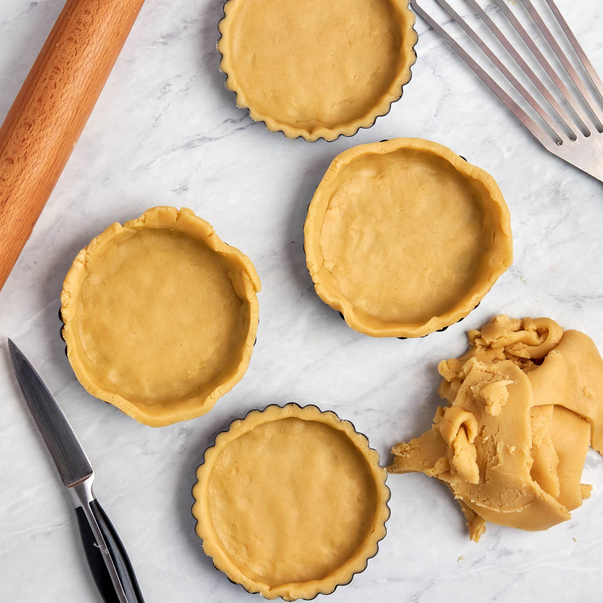 uncooked crust in 4 tart pans.