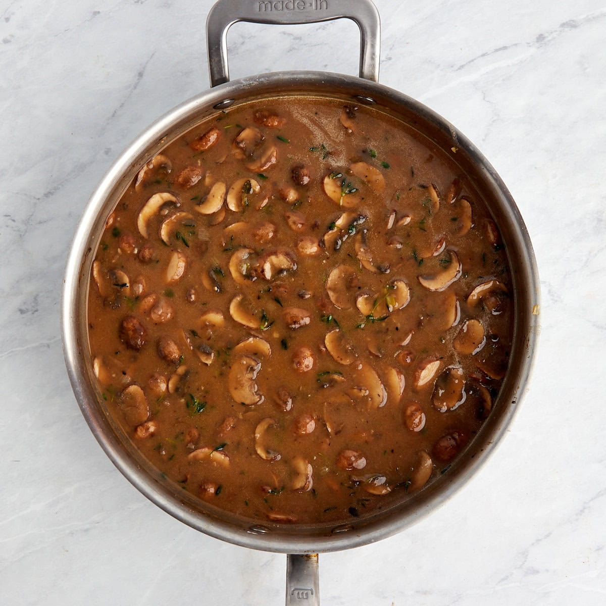 mushroom gravy in a large skillet as it cooks and thickens.