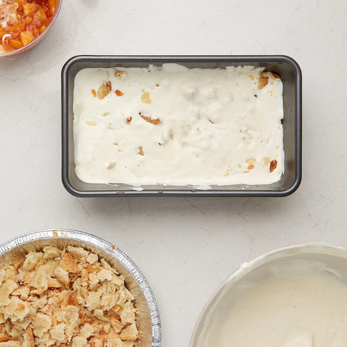 half of the ice cream mixture into an 8.5-by-4.5-inch loaf pan with half of the peach pie filling and half of the pie crust crumbles.