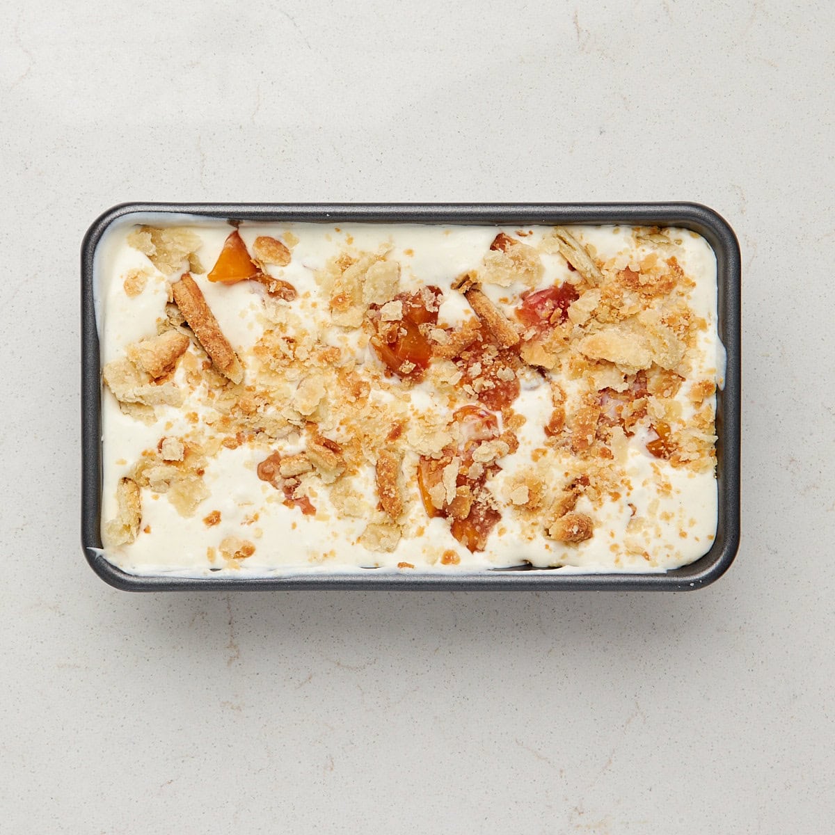 peach pie ice cream topped with remain pie crust and peach pie filling.