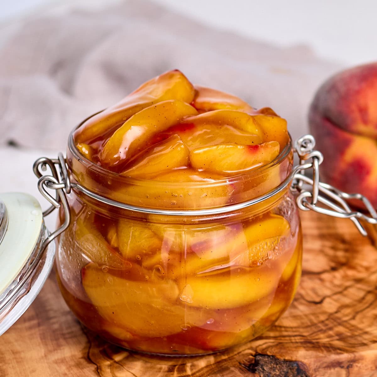 peach pie filling in a glass storage container.