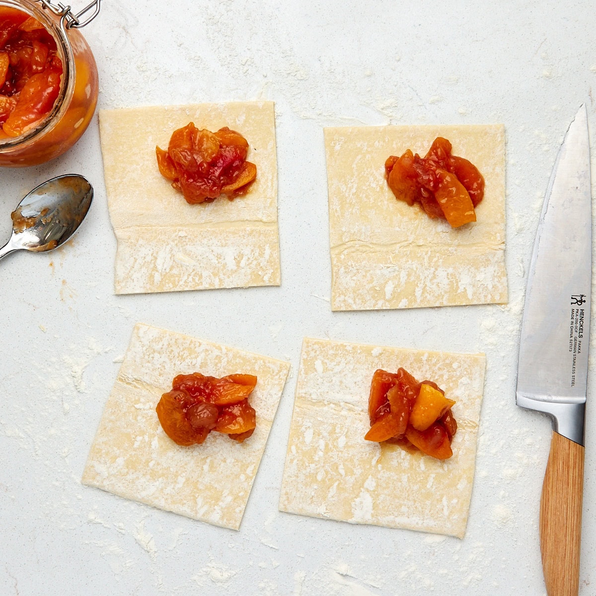 peach pie filling added to each square of puff pastry.