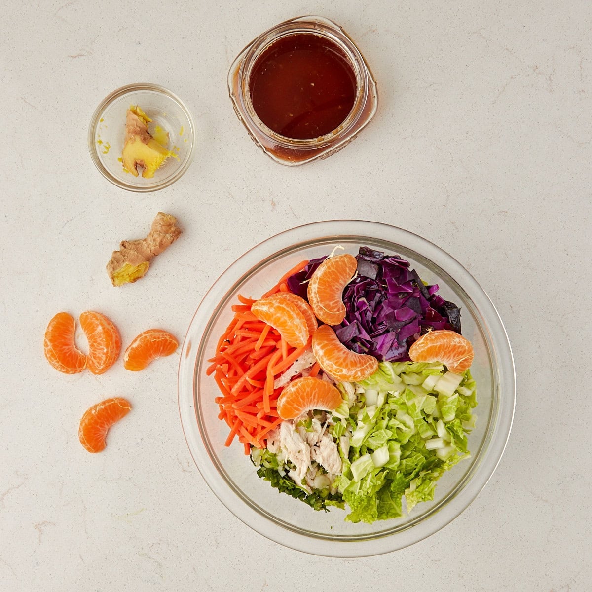 salad in a clear bowl before being dressed with salad dressing.