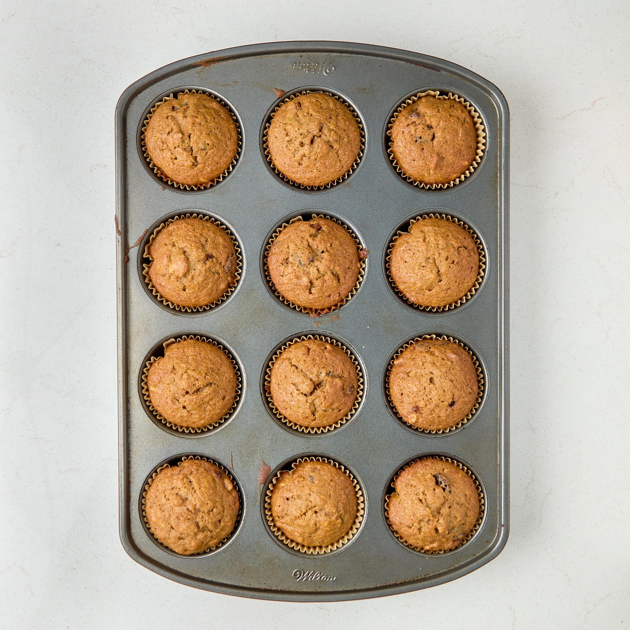 baked coffee cake muffins in a muffin tin.